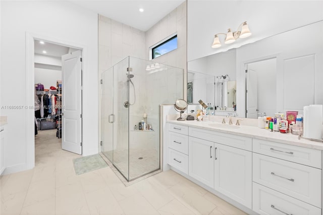 bathroom with a shower with door and vanity