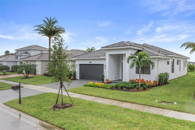 ranch-style home with a garage and a front lawn