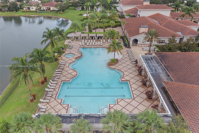 view of swimming pool featuring a water view and a patio area