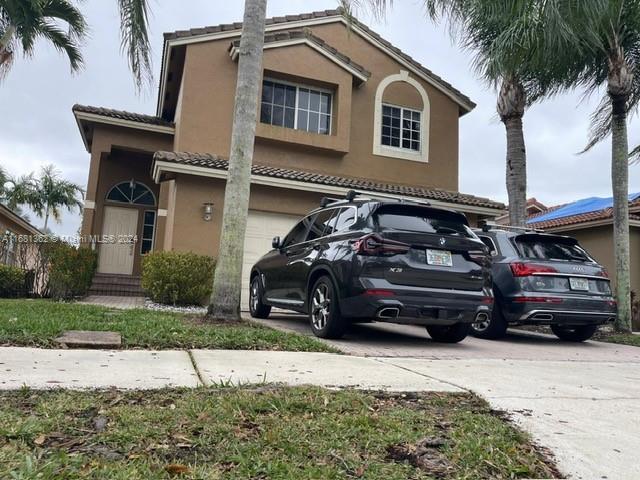 view of front of property with a garage