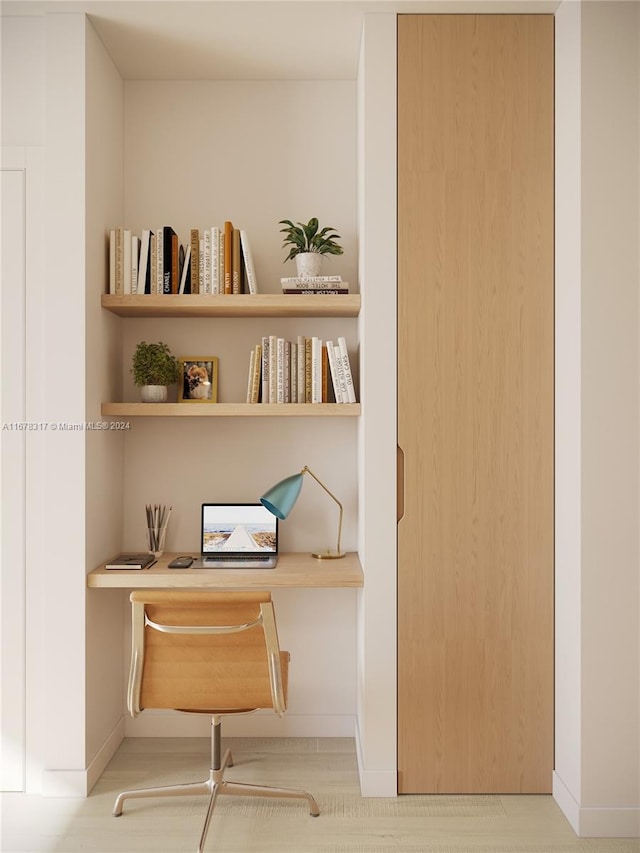 room details with built in desk and hardwood / wood-style floors