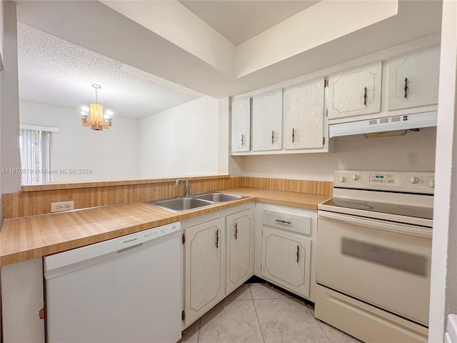 kitchen with decorative light fixtures, white cabinets, sink, and white appliances