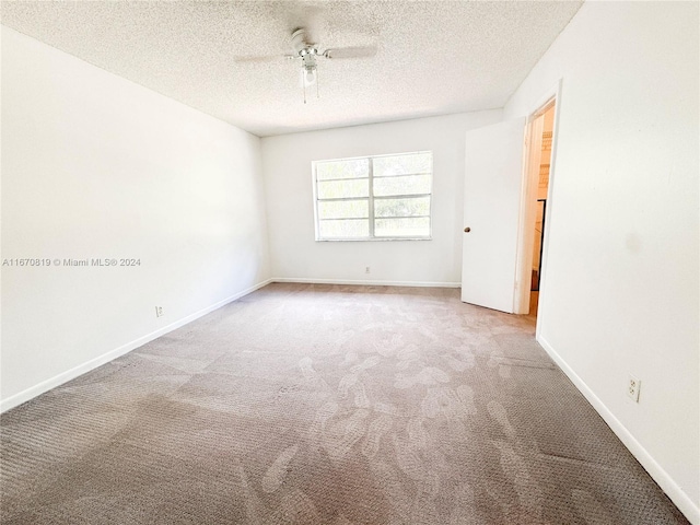 unfurnished room featuring light carpet, a textured ceiling, and ceiling fan