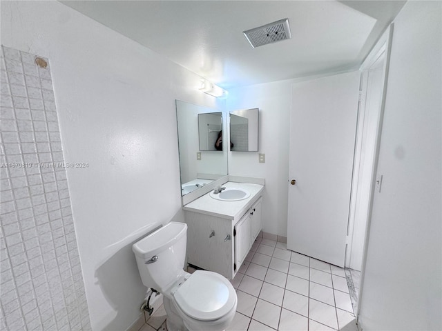 bathroom featuring vanity, toilet, and tile patterned floors