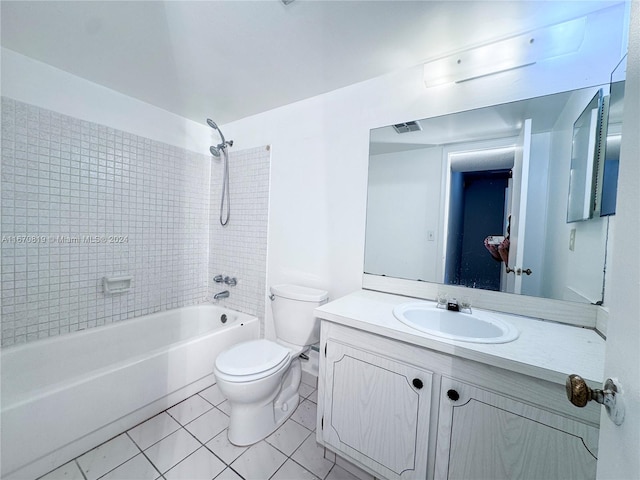 full bathroom featuring vanity, tiled shower / bath, toilet, and tile patterned floors