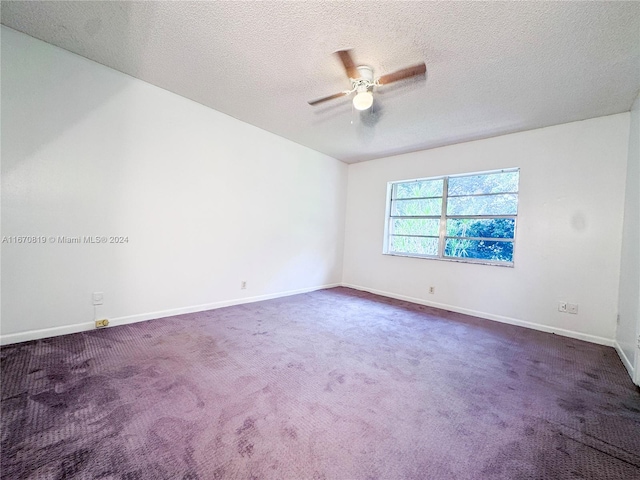 carpeted empty room featuring a textured ceiling and ceiling fan