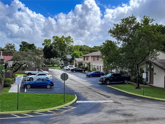 view of vehicle parking featuring a lawn