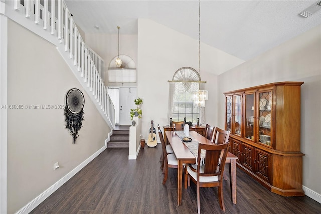 dining space featuring dark wood-style floors, a notable chandelier, visible vents, stairway, and baseboards