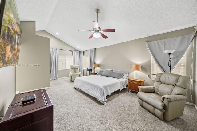 bedroom with lofted ceiling, ceiling fan, a textured ceiling, and light colored carpet