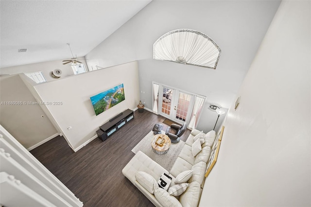 living area with dark wood-style floors, french doors, high vaulted ceiling, and baseboards