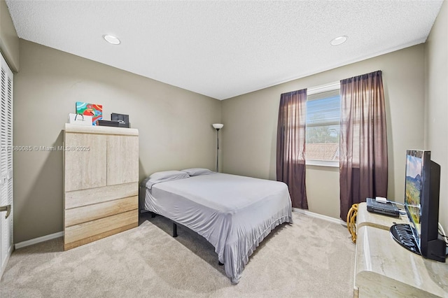 bedroom featuring carpet floors, recessed lighting, a textured ceiling, and baseboards