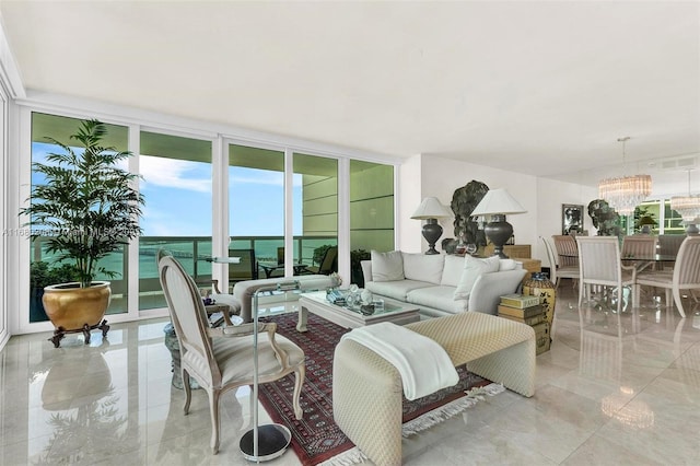 living room featuring a water view, an inviting chandelier, and floor to ceiling windows