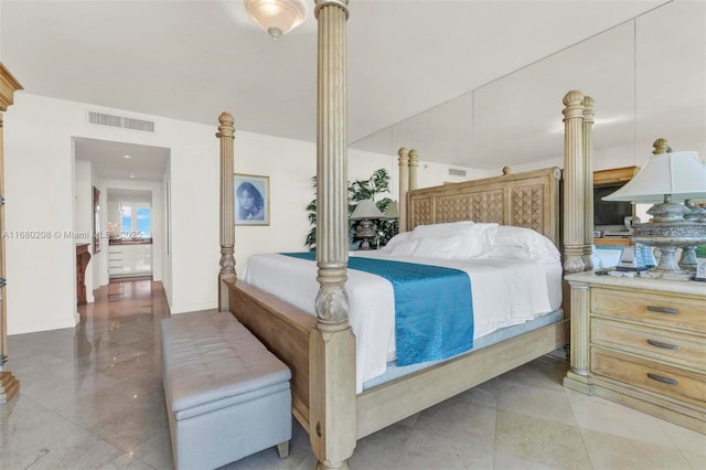 bedroom with ornate columns and visible vents