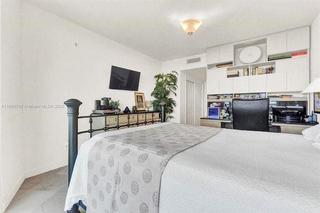 bedroom with visible vents and baseboards