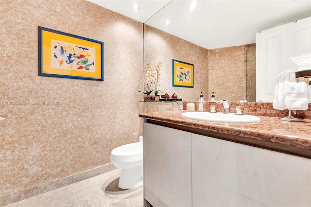 bathroom with tile patterned flooring, vanity, and toilet