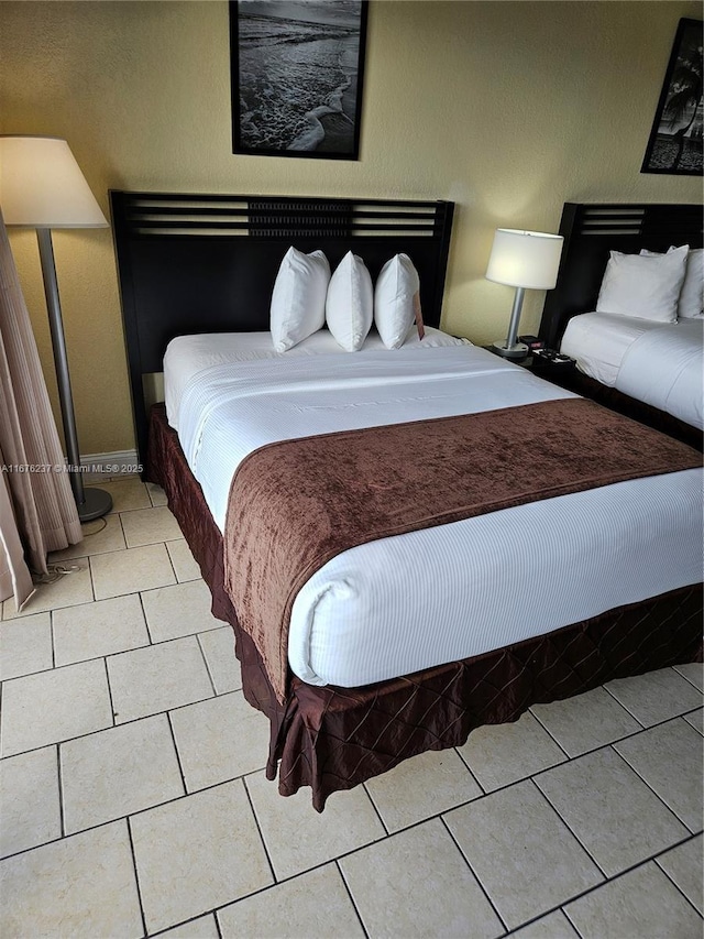 bedroom with light tile patterned floors