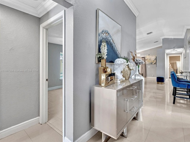 hall featuring ornamental molding and light tile patterned floors