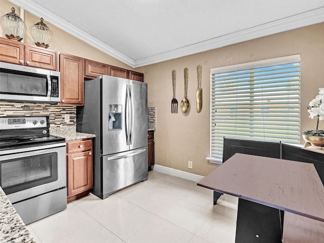 kitchen featuring decorative backsplash, stainless steel appliances, crown molding, vaulted ceiling, and light tile patterned floors