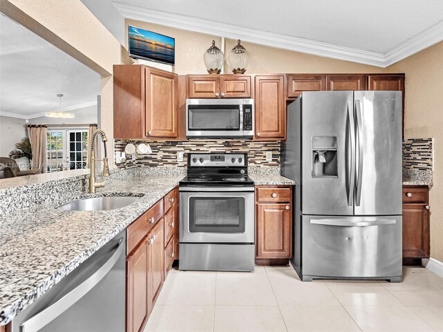 kitchen with crown molding, lofted ceiling, appliances with stainless steel finishes, and sink