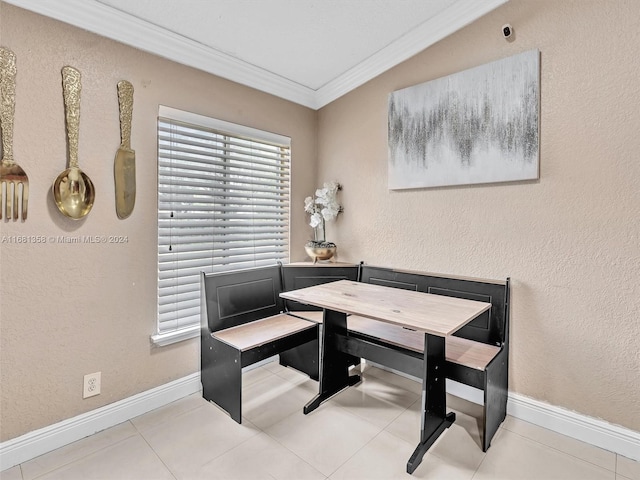 tiled dining room featuring crown molding