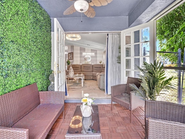 sunroom featuring vaulted ceiling and ceiling fan