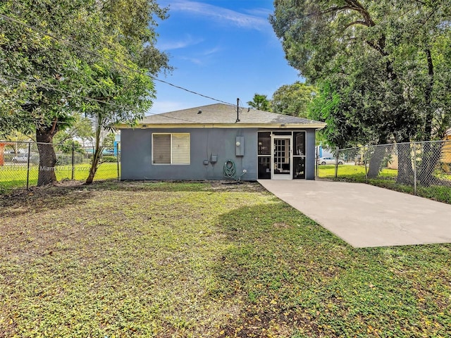 back of property with a yard and a sunroom