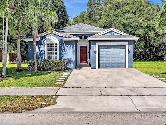 single story home featuring a front yard and a garage