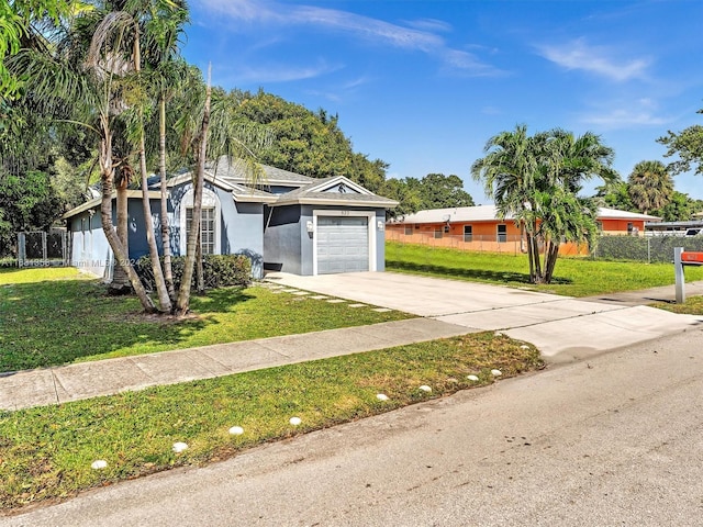 view of front of property featuring a front lawn and a garage