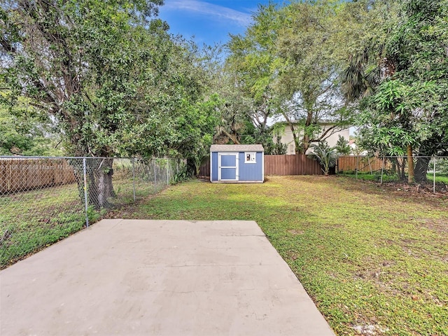 view of yard with a shed and a patio area