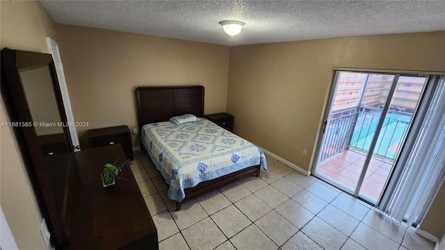 tiled bedroom with access to outside and a textured ceiling