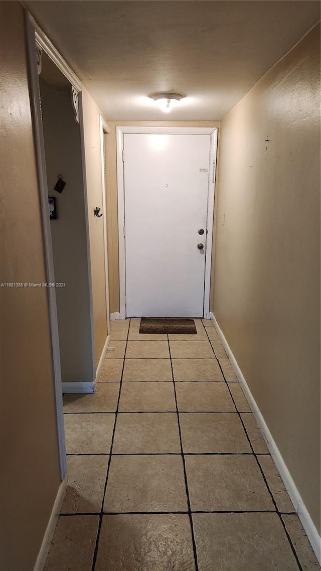 hall with light tile patterned floors