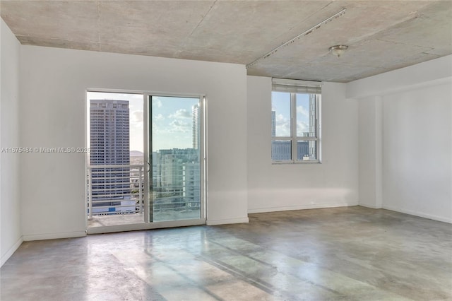 unfurnished room with concrete floors and a wealth of natural light