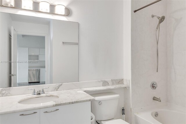 full bathroom with vanity, tiled shower / bath combo, and toilet