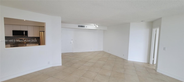 empty room featuring a textured ceiling