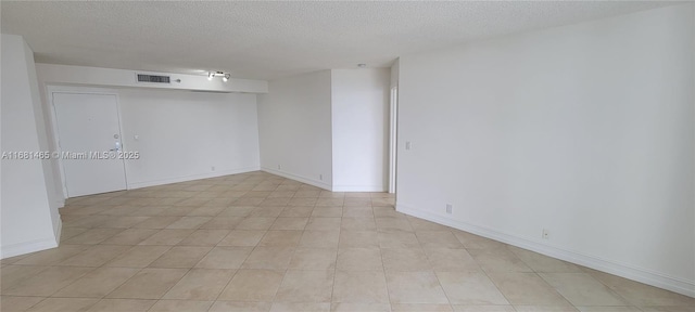 empty room featuring a textured ceiling