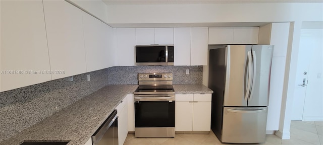 kitchen featuring white cabinetry, stainless steel appliances, and stone countertops