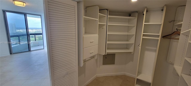 spacious closet with light tile patterned floors