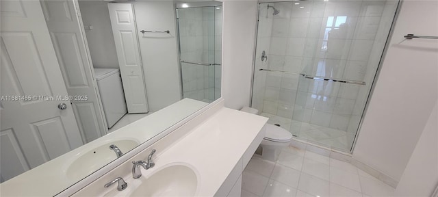 bathroom featuring walk in shower, vanity, toilet, and washer / dryer