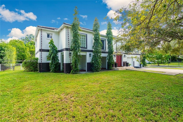 view of front of home featuring a front yard and a garage