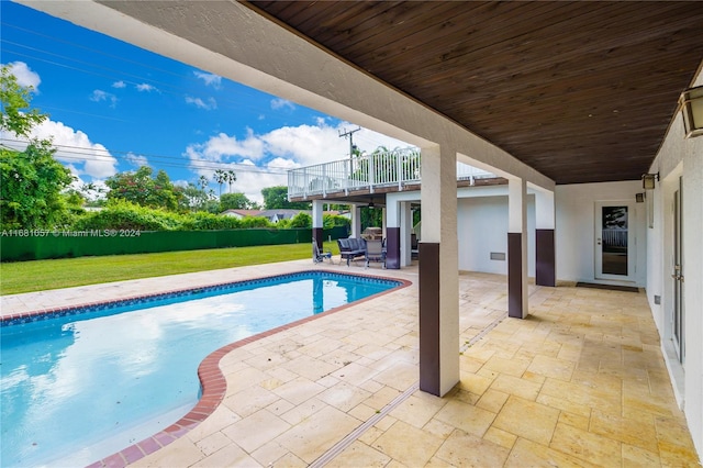 view of swimming pool featuring a yard and a patio