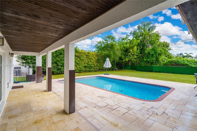 view of pool featuring a yard and a patio