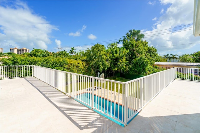 view of patio / terrace with a fenced in pool