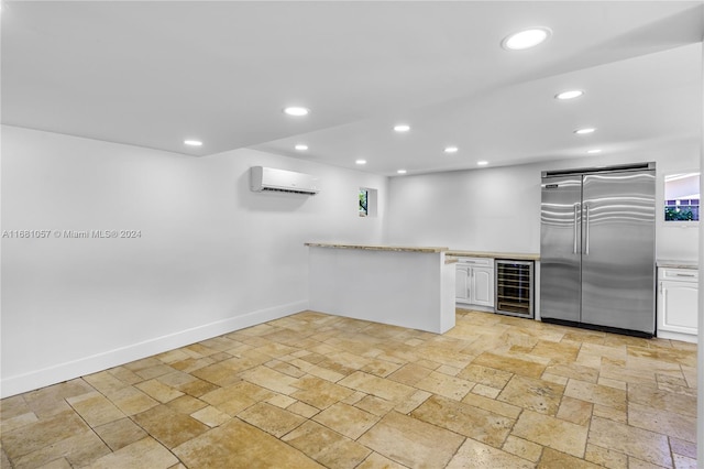 kitchen featuring white cabinets, wine cooler, an AC wall unit, and built in refrigerator