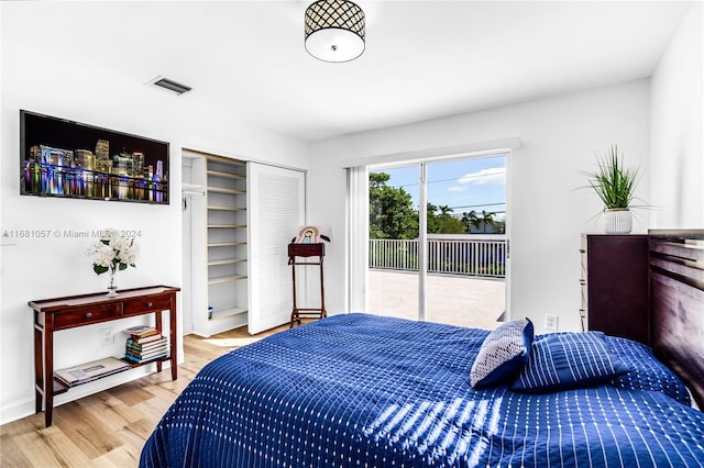 bedroom with access to exterior, a closet, and hardwood / wood-style flooring