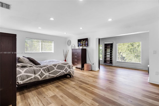 bedroom featuring multiple windows and light hardwood / wood-style floors