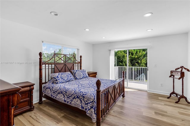 bedroom with light hardwood / wood-style floors, multiple windows, and access to exterior