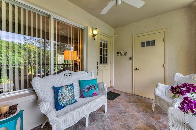 property entrance with ceiling fan and a patio area