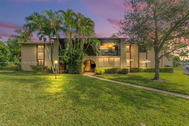 442 Pine Glen Ln Unit D-2, Green Acres, FL 33463 - view of front facade with a balcony, a front yard, and stucco siding