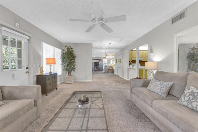 carpeted living room with a textured ceiling and ceiling fan