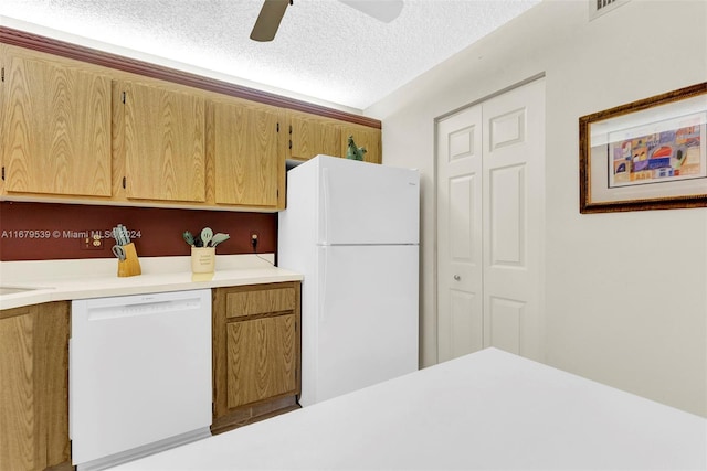 kitchen featuring ceiling fan, white appliances, and a textured ceiling